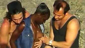 Three Men And One Woman Engage In Sexual Activity On The Coast